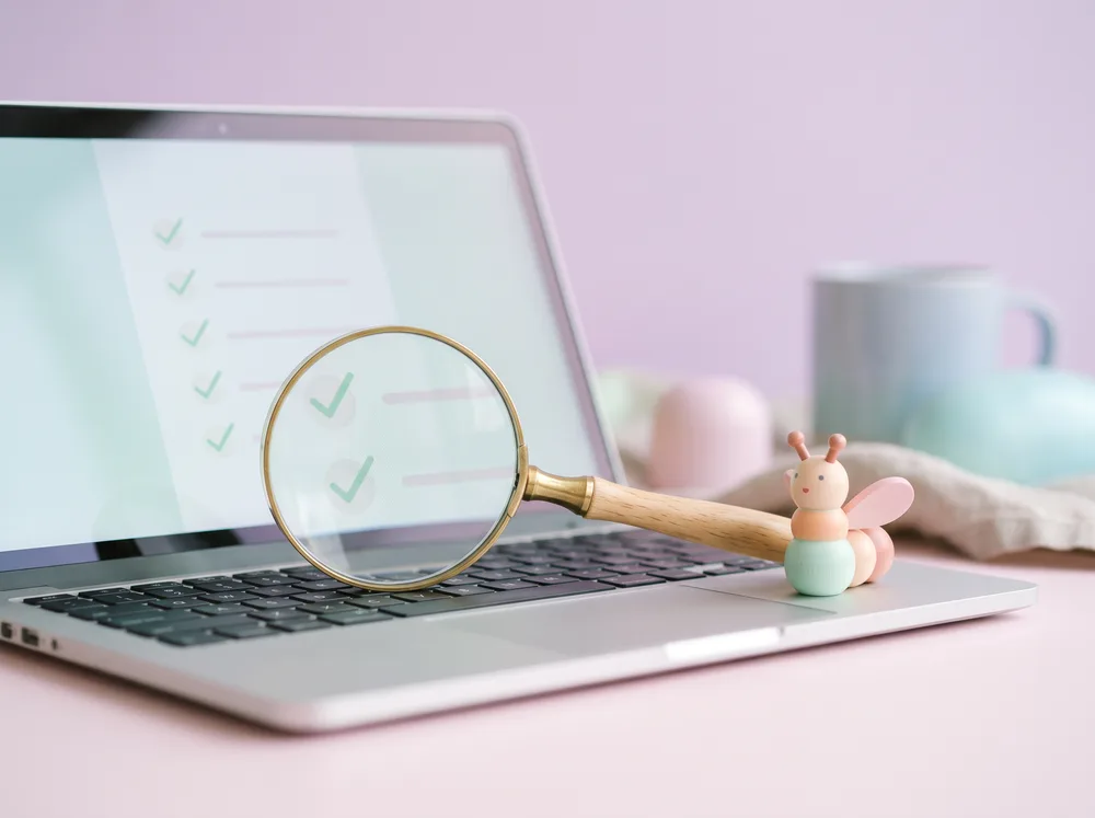A magnifying glass over a checklist with green checkmarks
